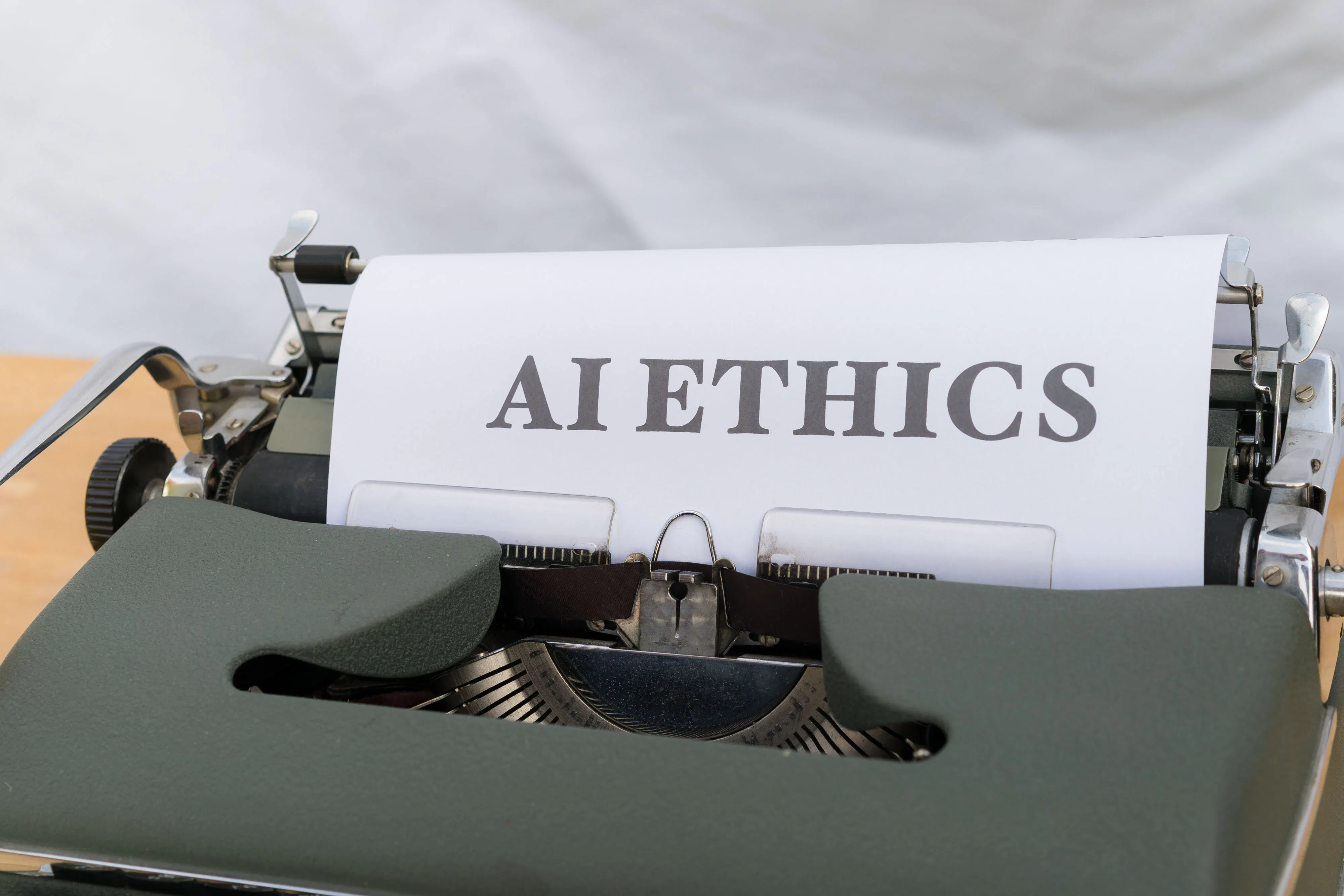 An old typewriter with the words 'AI ETHICS' typed on a sheet of paper, emphasizing the importance of ethical considerations when using AI writing tools and AI article writer for content creation.