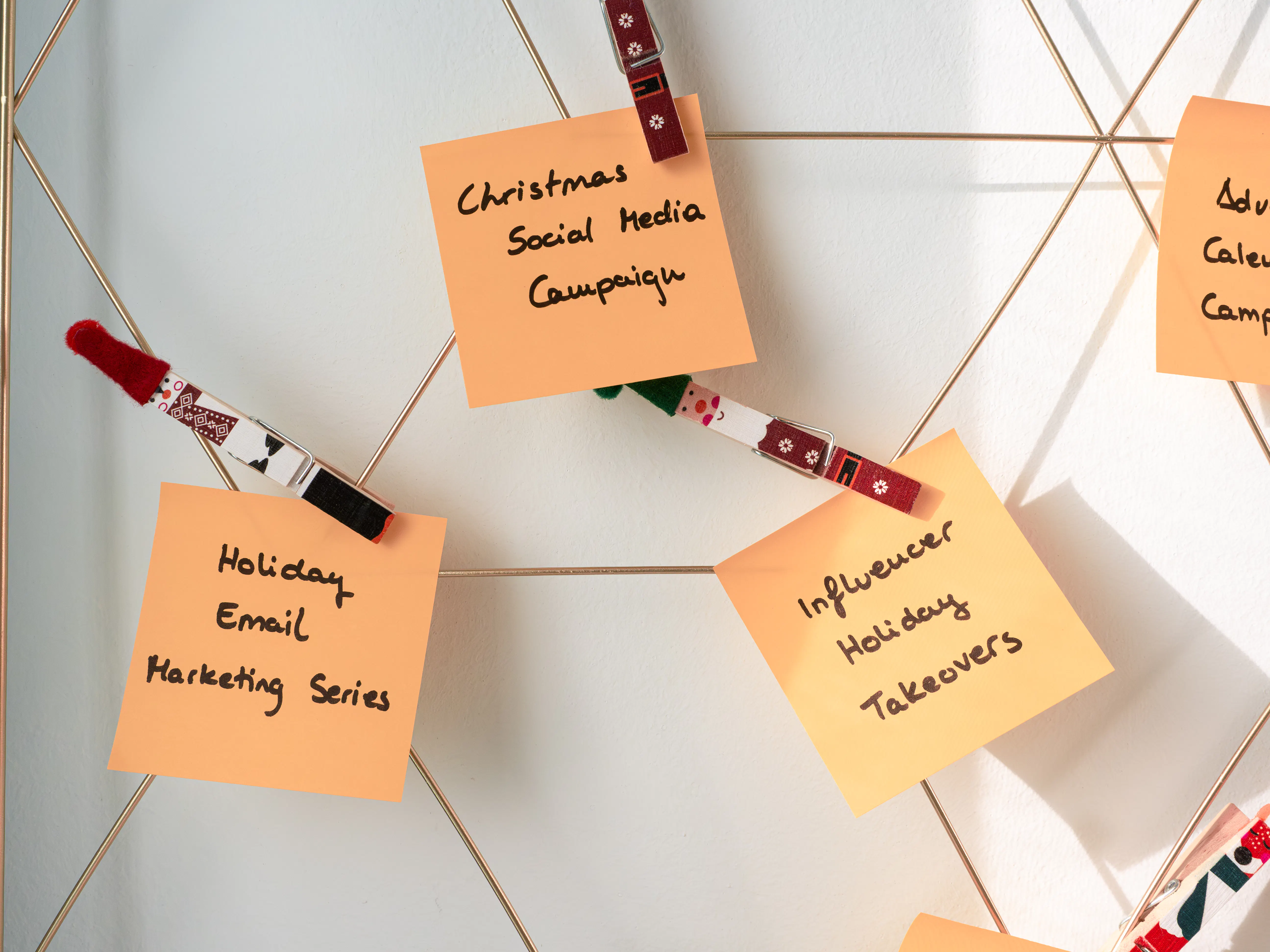 A holiday social media campaign calendar with sticky notes, showcasing content creation tools that could assist an AI blog writer in planning engaging content for 2025 to improve blog post visibility.