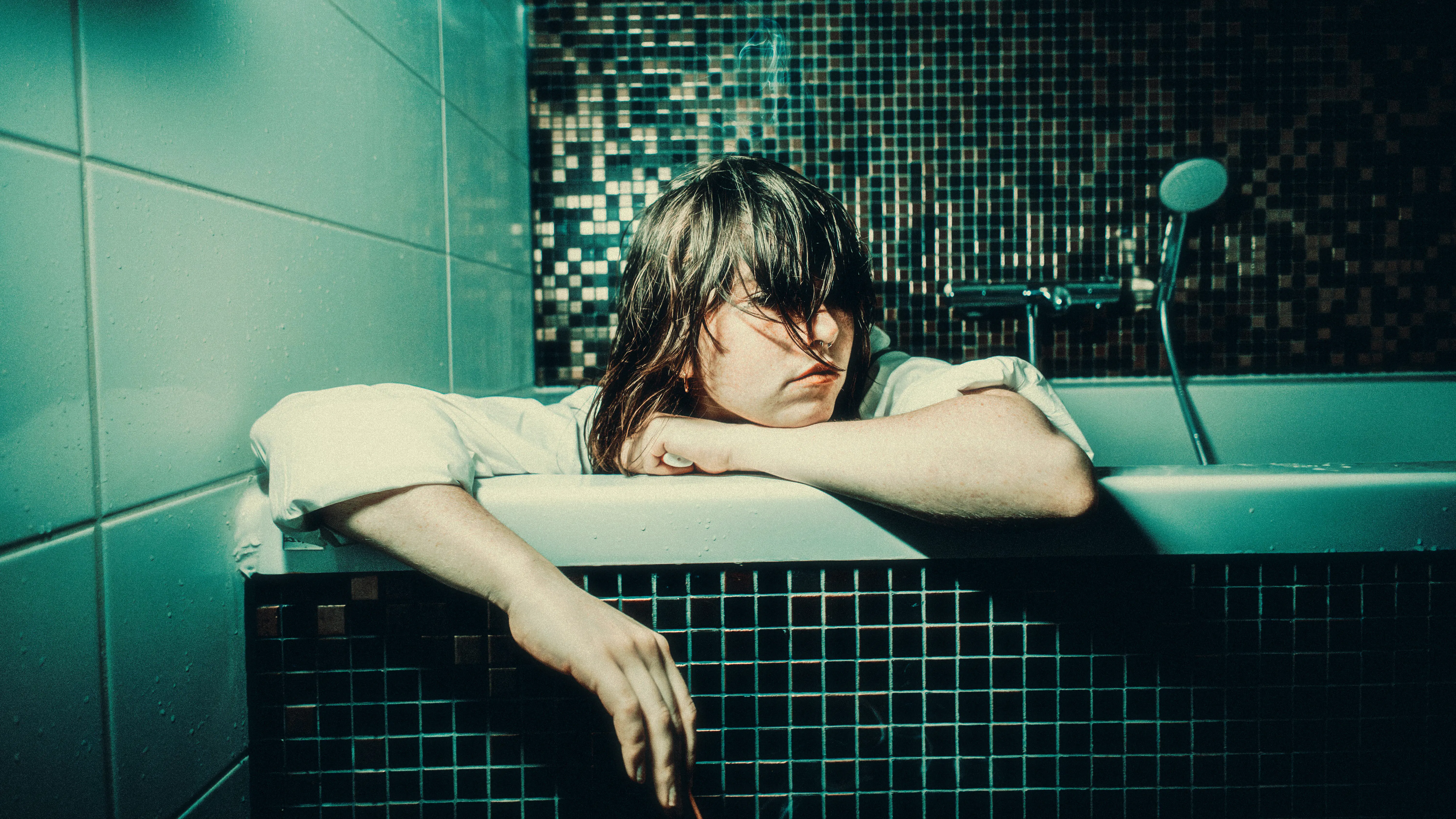 Image of a person in a bathtub, potentially symbolizing the need for relaxation and inspiration during AI content creation processes.