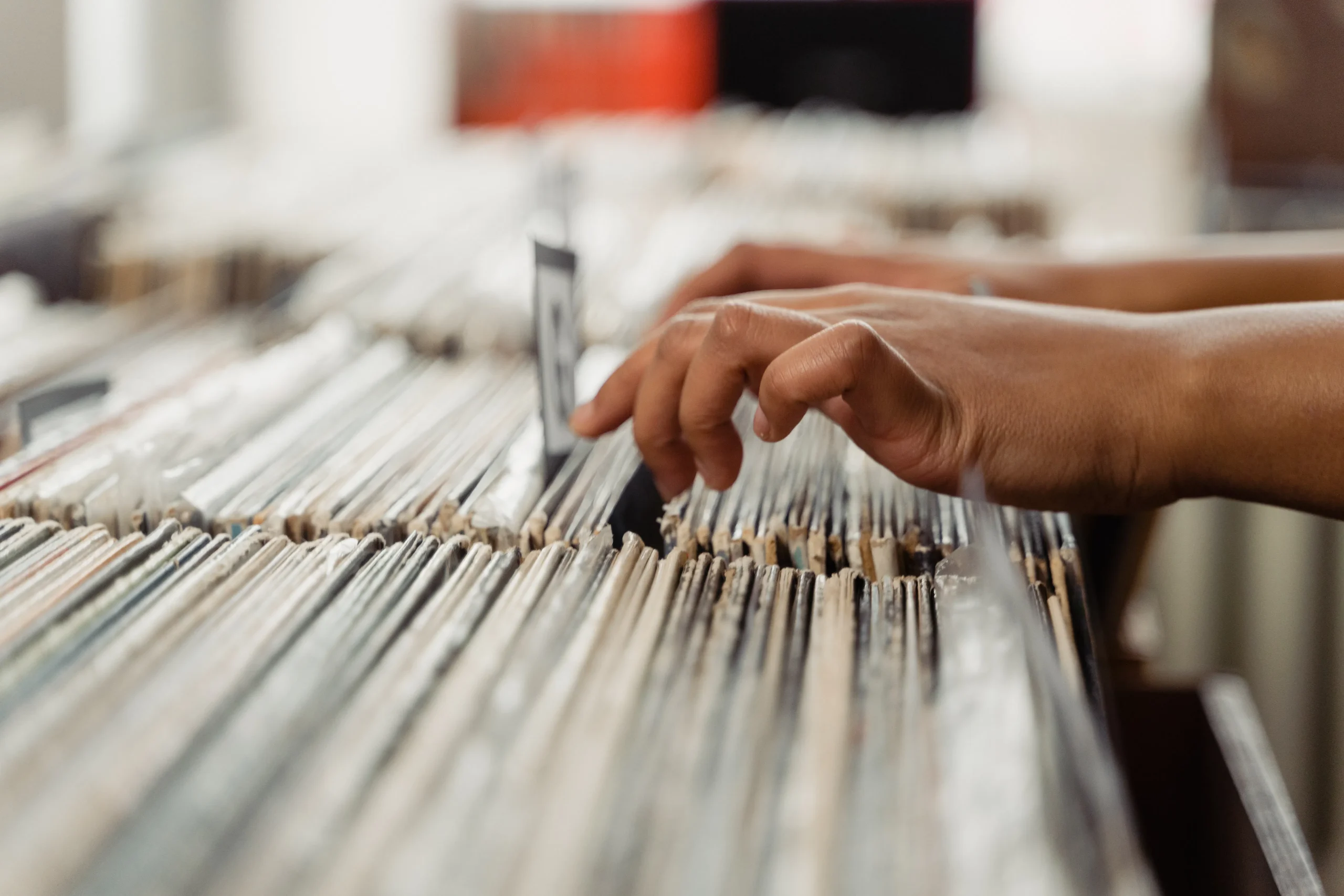 Close-up of hands searching through files, representing the detailed work involved in content strategy and SEO content optimization.