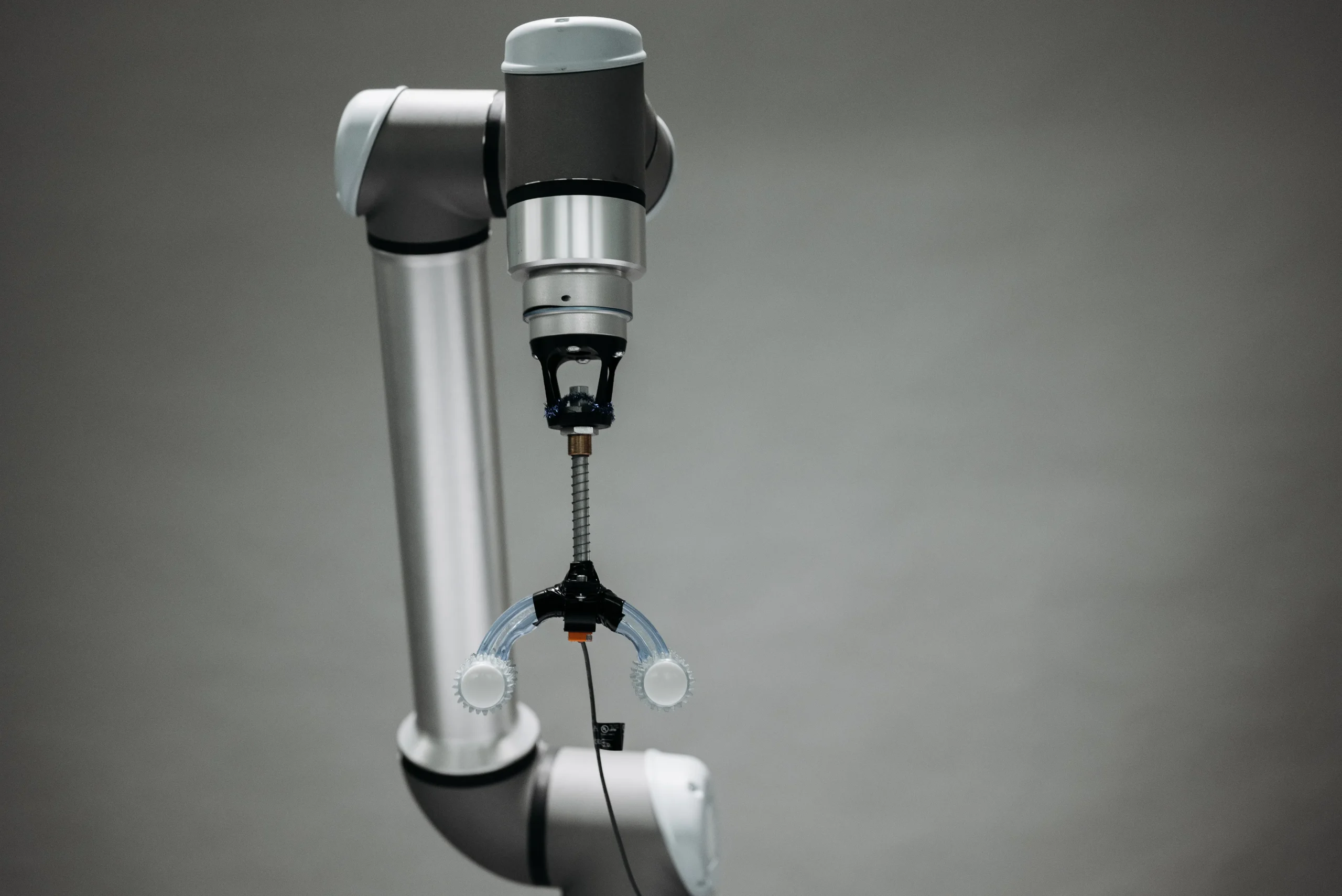 Robotic arm holding a tool, reflecting the technological aspect of AI writing software and AI SEO tools.