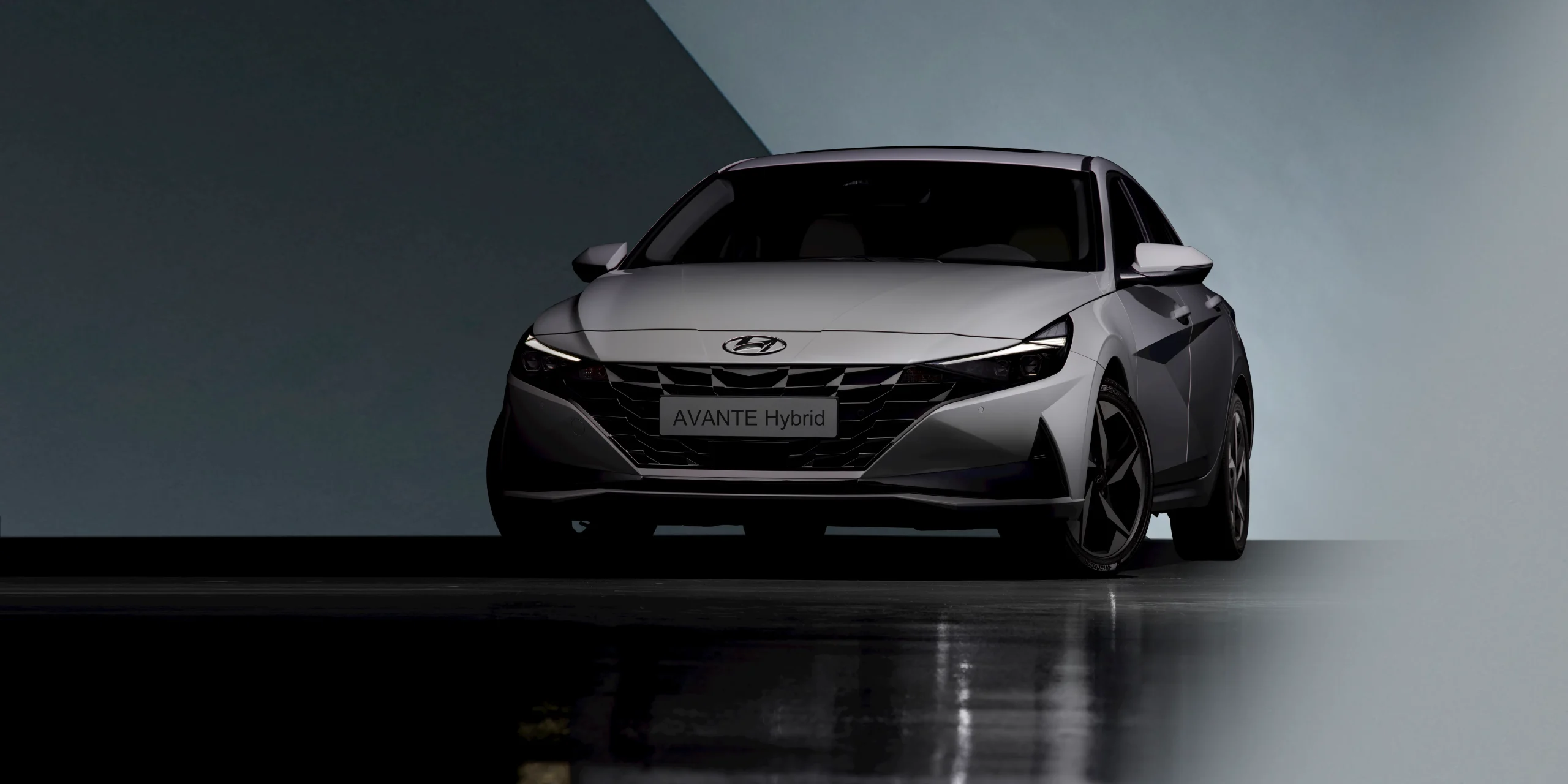 Front view of a silver Hyundai Avante Hybrid car on display.