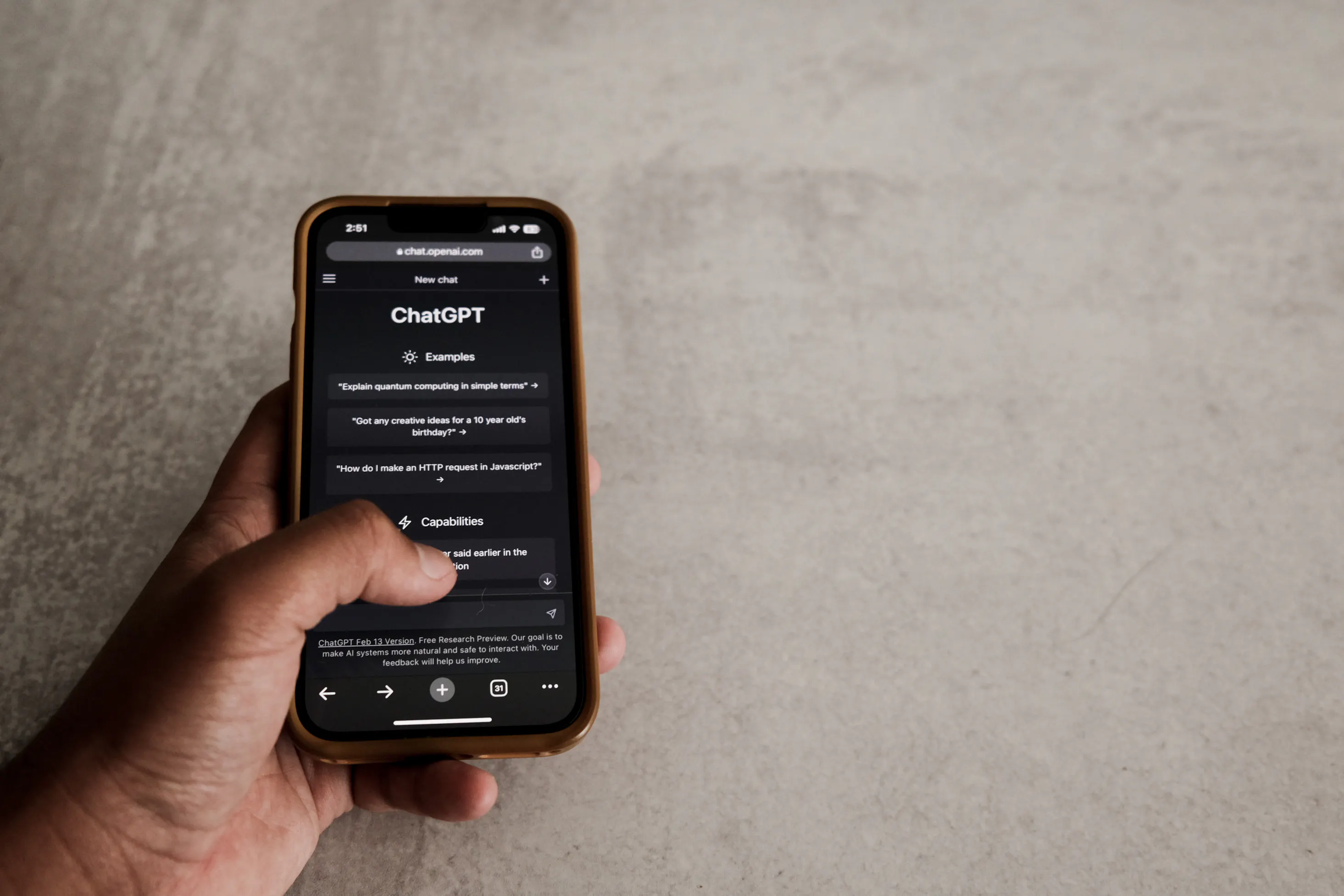 Hand using ChatGPT on a smartphone, a helpful AI tool for content generation.