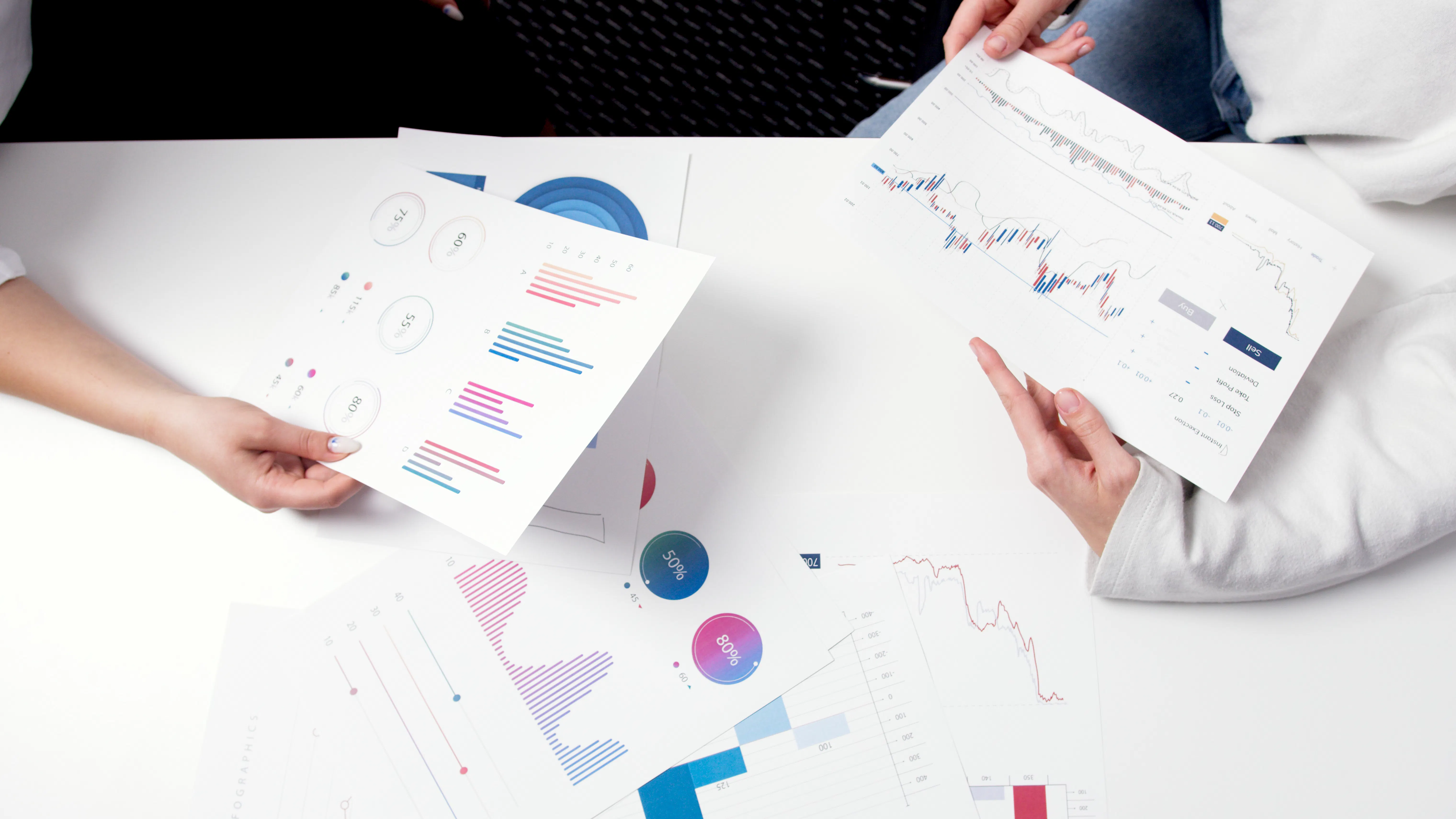 Two people analyzing SEO reports and charts to boost website SEO optimization.