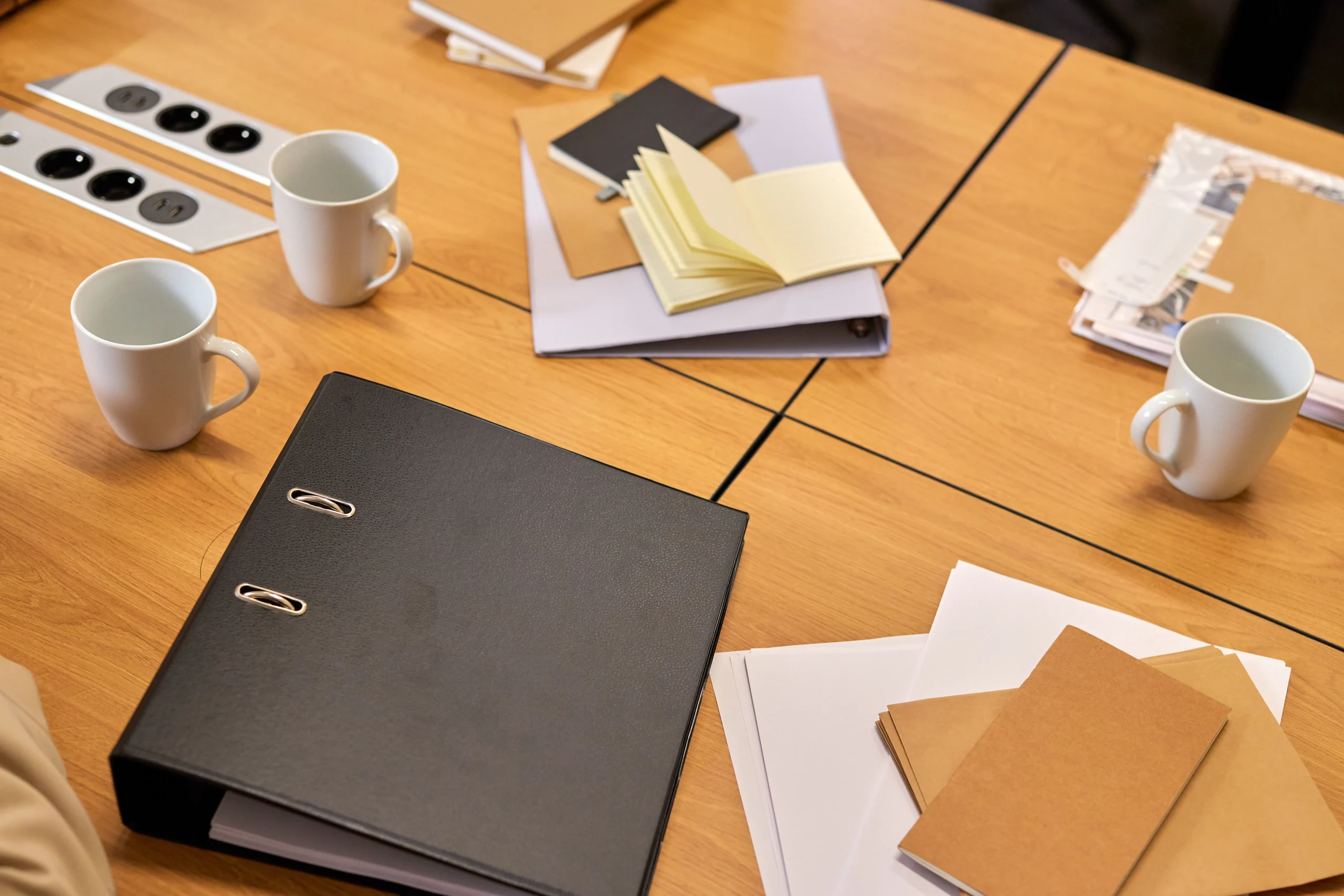 Office desk with notebooks and mugs for niche site marketing and AI SEO article writer planning.
