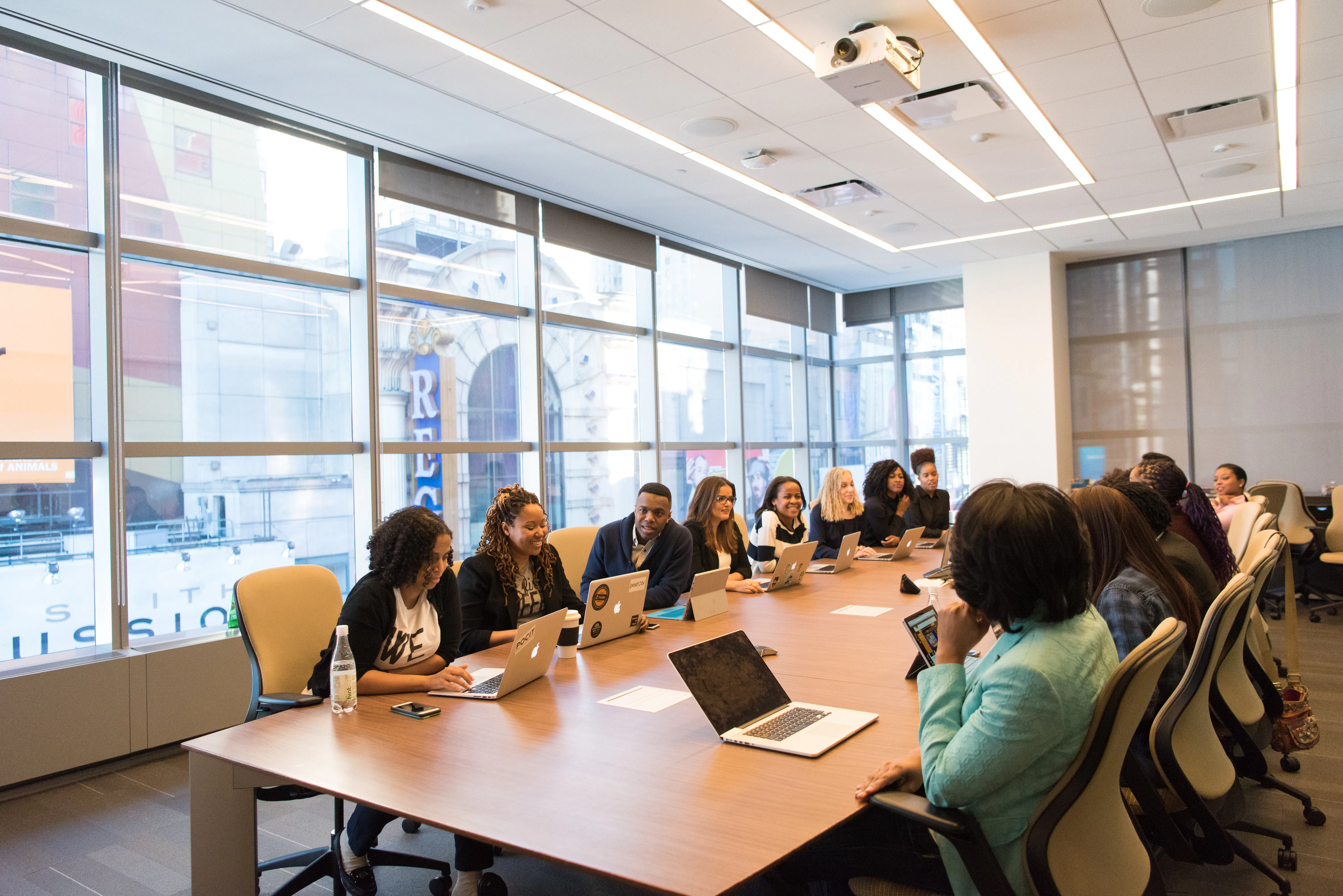 A team using laptops in a meeting, highlighting how seo software ROI drives organic traffic growth.