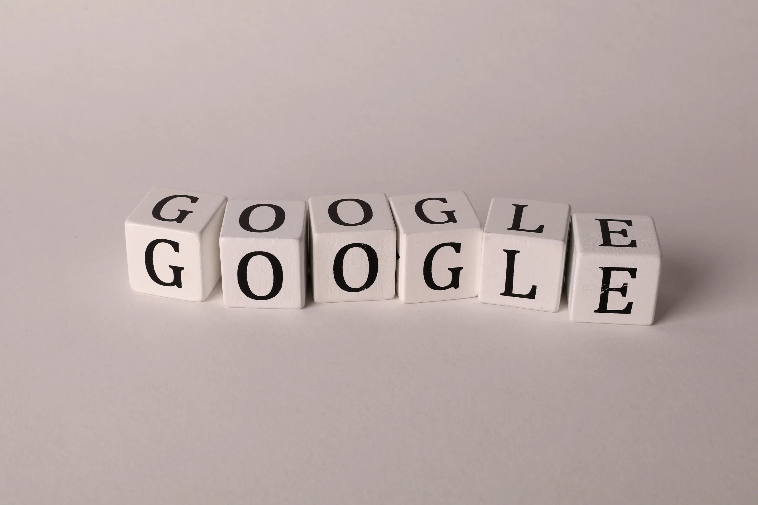 Google spelled out on blocks, highlighting SEO content software and blog content quality standards.