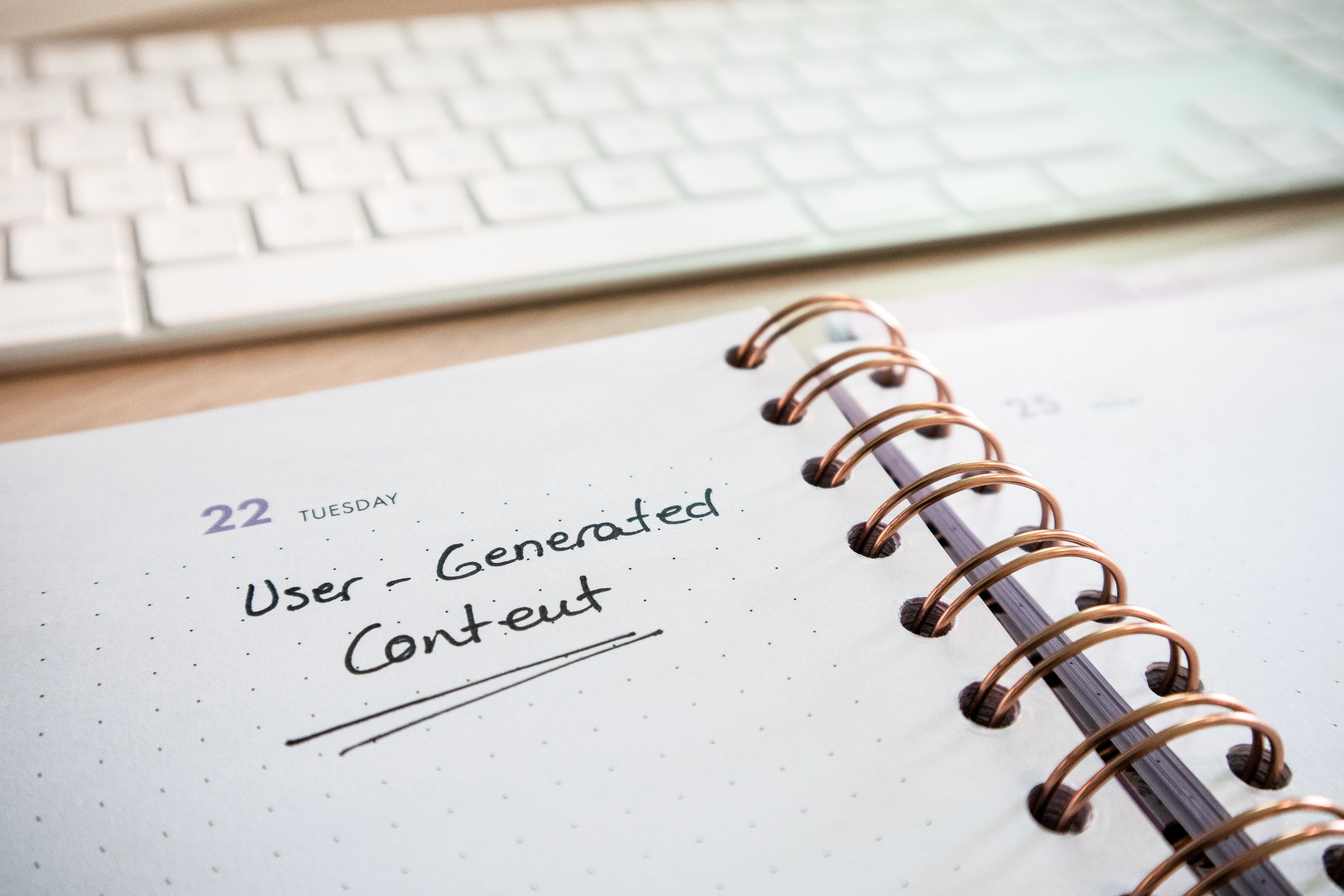A notebook with User-Generated Content written on it, helping with AEO optimization strategies.