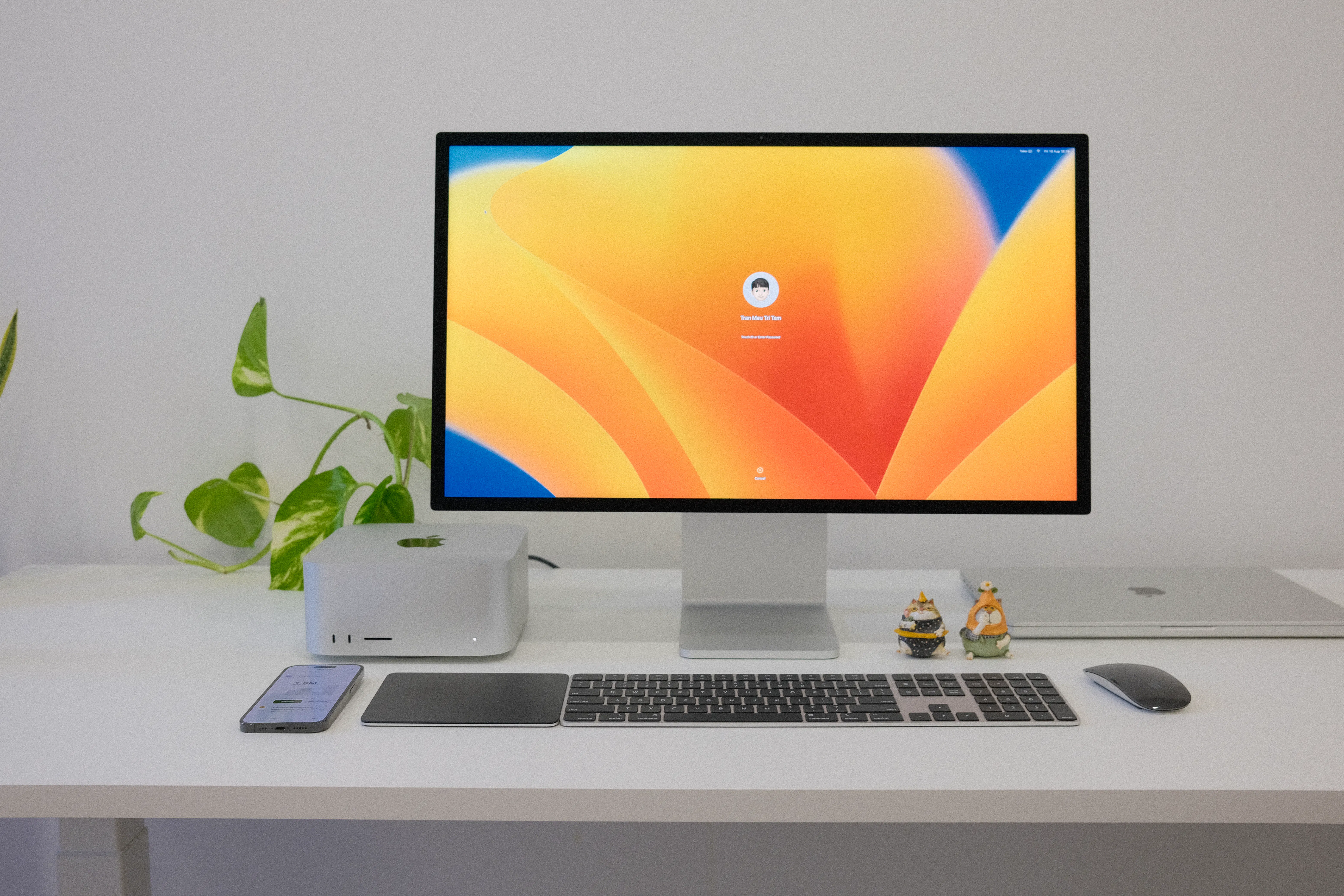 Modern computer workstation with a large monitor, Mac Studio, keyboard, and mouse, ready for using AI writing assistant tools.