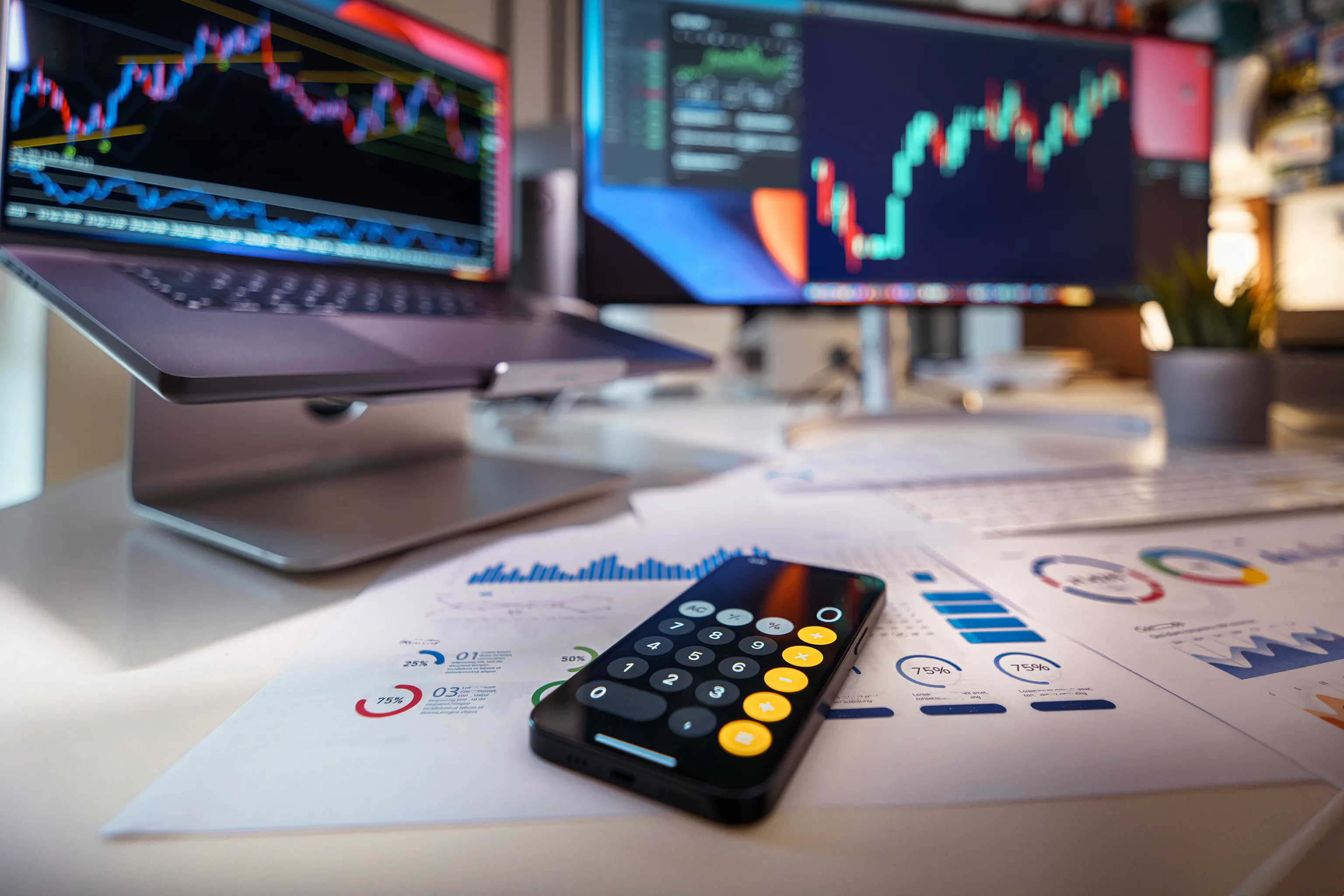 A desk with screens showing data and a calculator, comparing paid vs free ai writers for seo optimization.