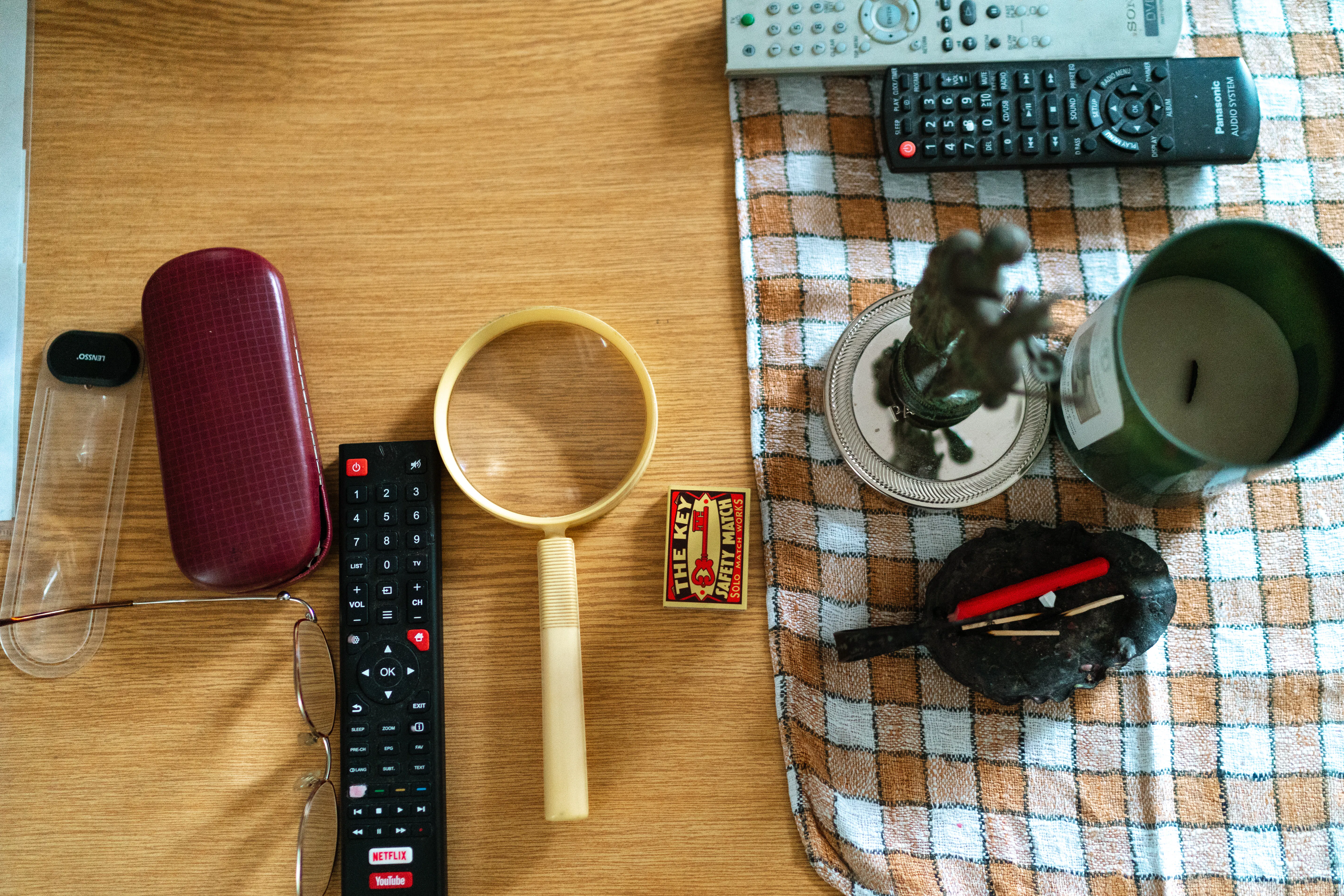 A magnifying glass and remote controls on a desk, representing deep analysis in our SEO growth case study.