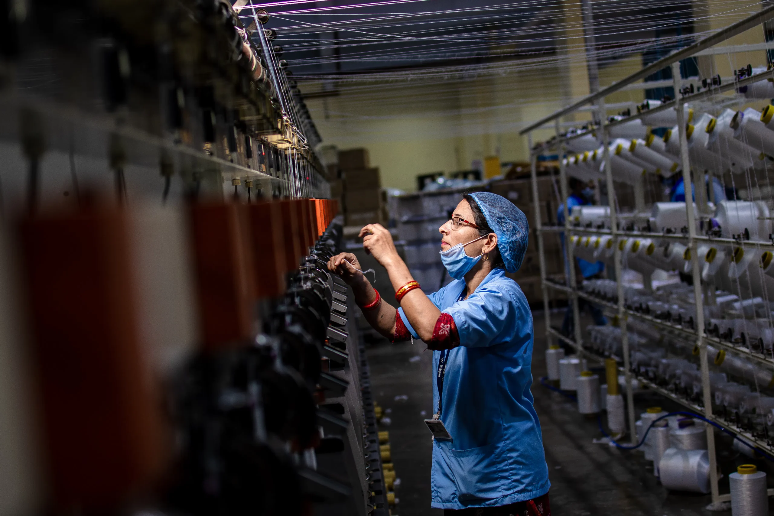 A factory worker managing machinery, representing the need for streamlining blog production processes.