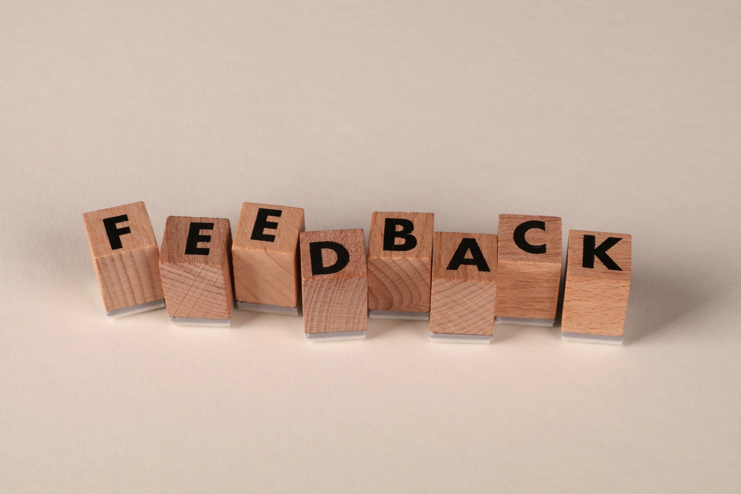 Wooden blocks spelling feedback for improving ai article writer and blog content quality.