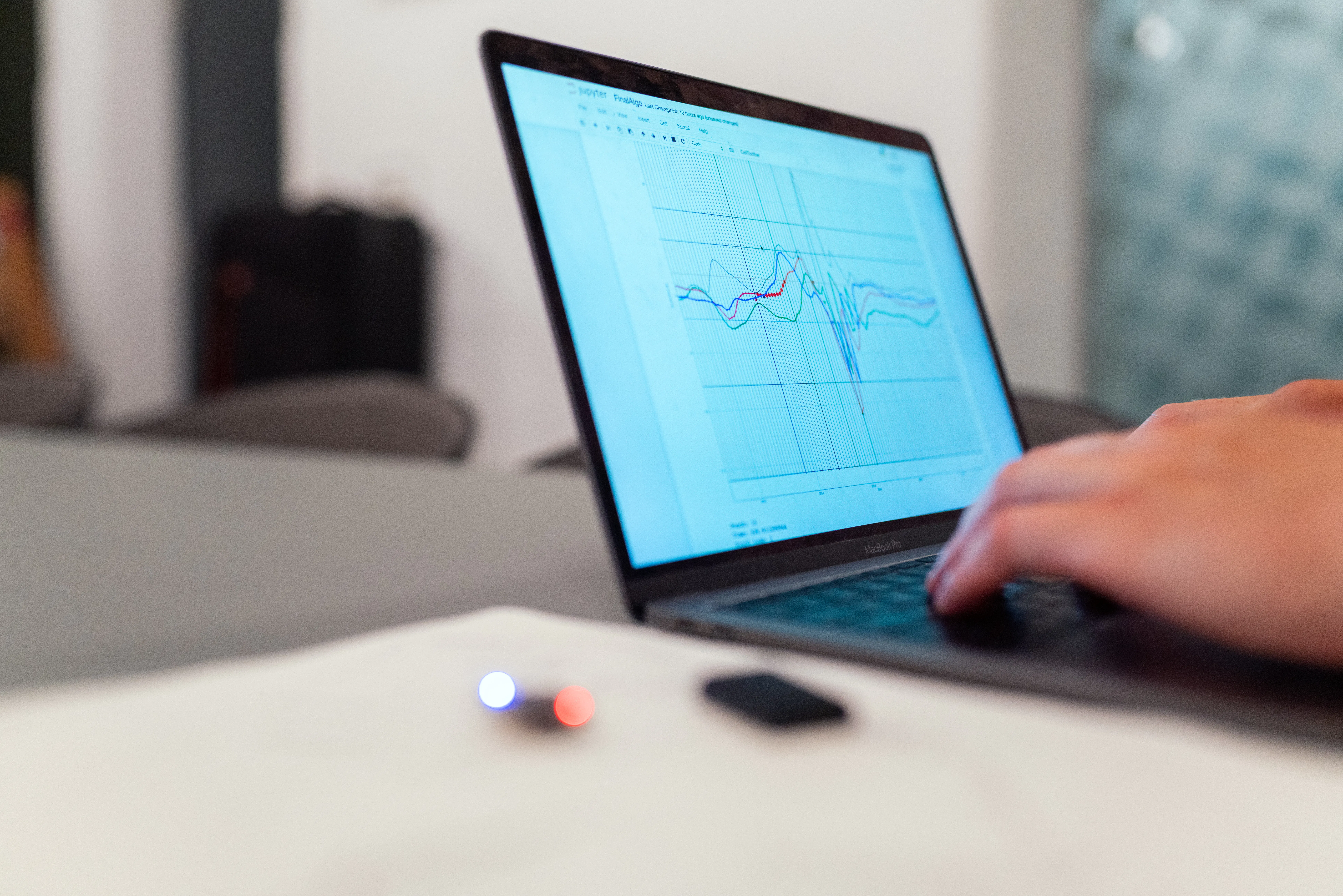 A person using a laptop to analyze data, representing effective seo content writing software in action.
