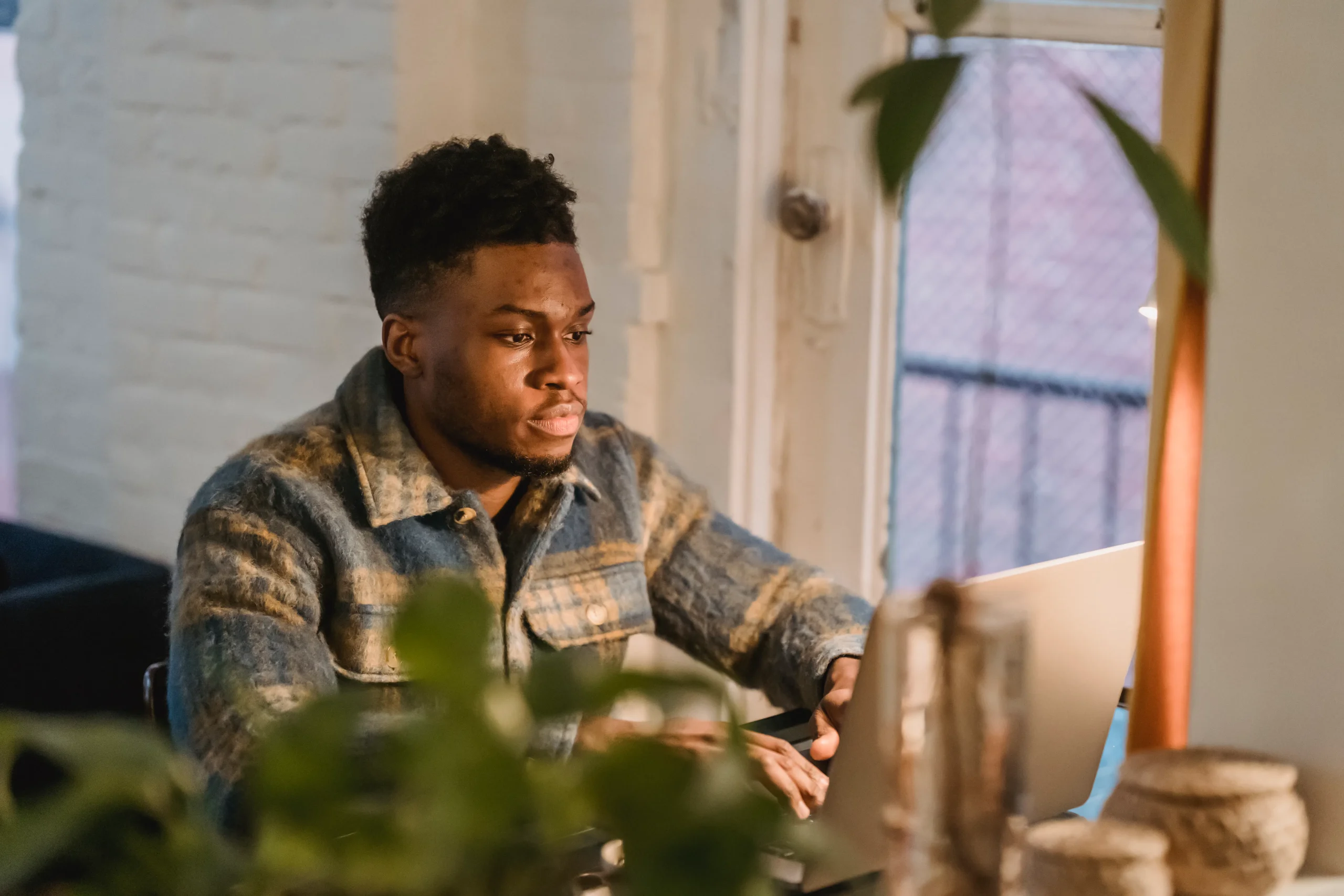 Man using a laptop to manage seo automated software and improve his website's google search rankings.