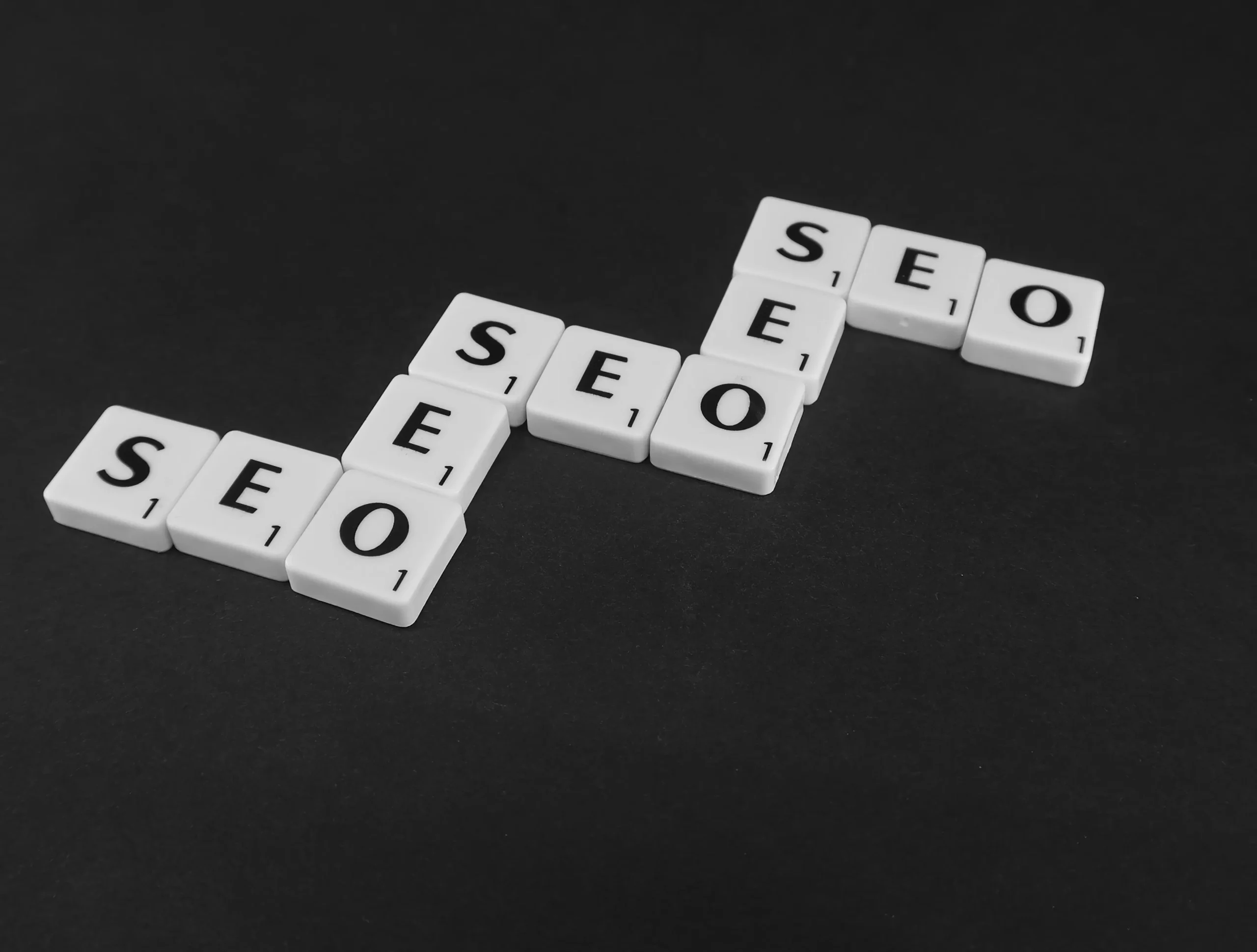 Scrabble tiles spelling SEO in a stair pattern, illustrating an effective SEO content workflow.