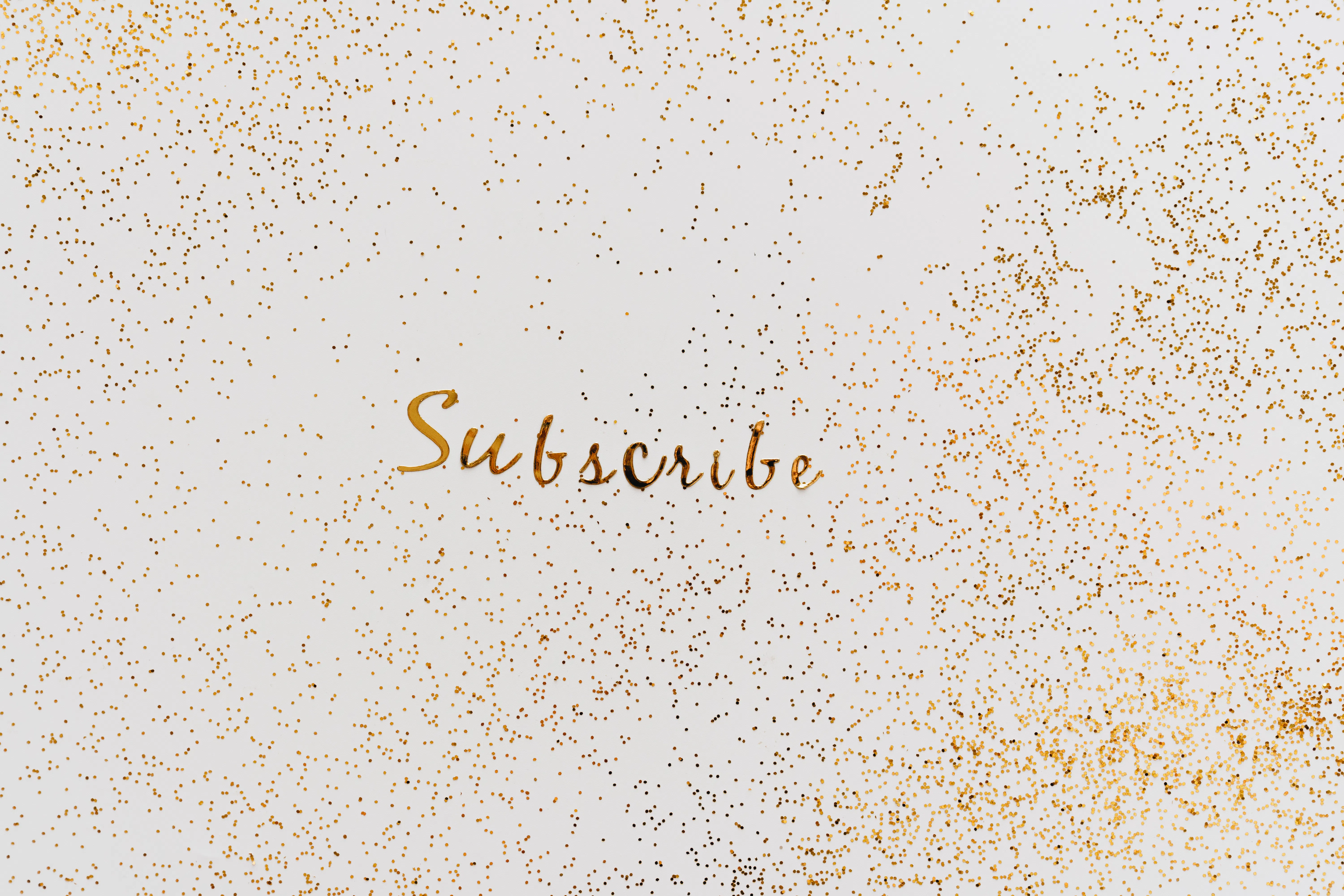 Gold glitter background with the word Subscribe, perfect for an ai article generator blog.