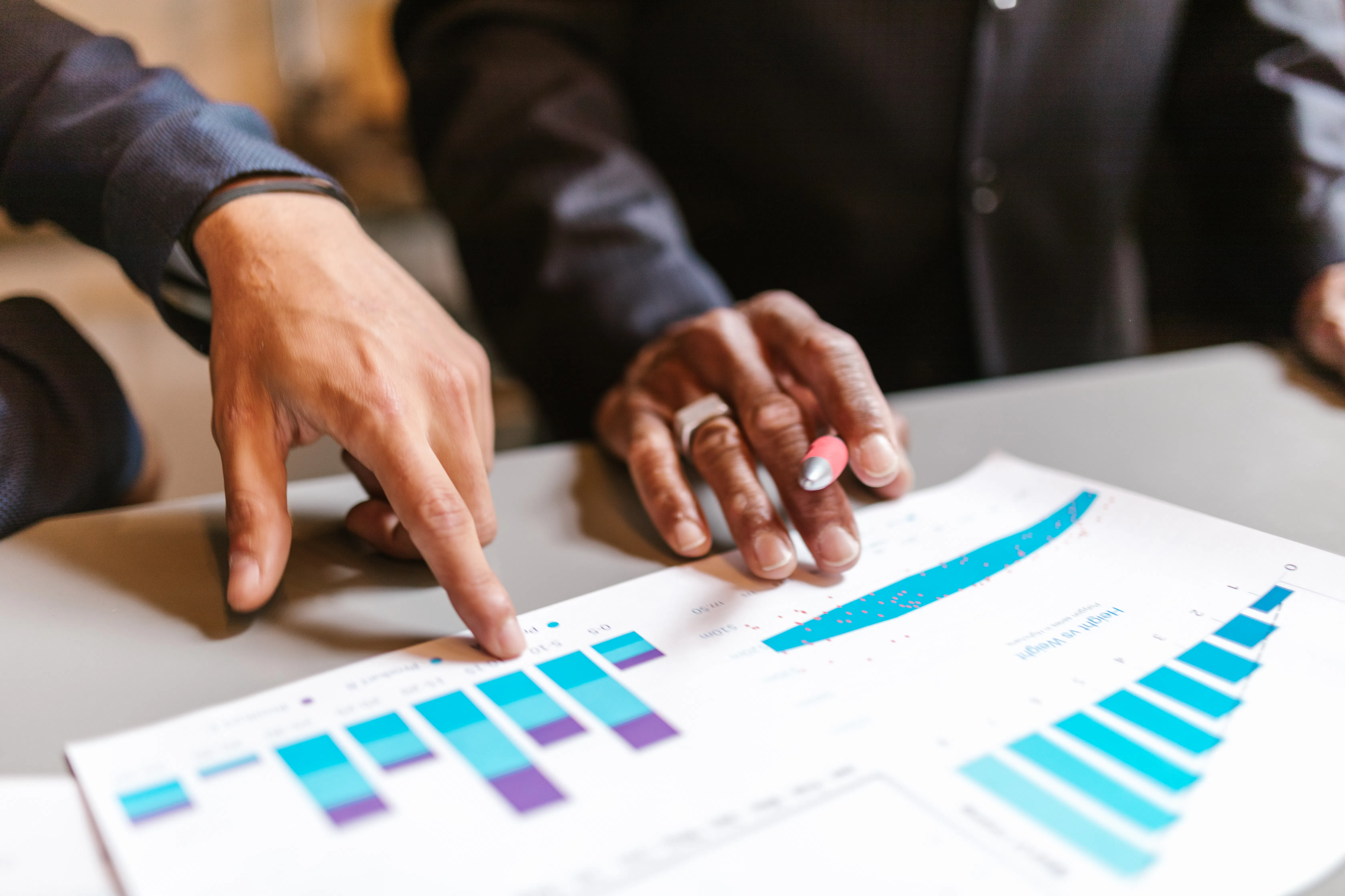 Business people reviewing data from an automated content creation tool to avoid SEO cannibalization.