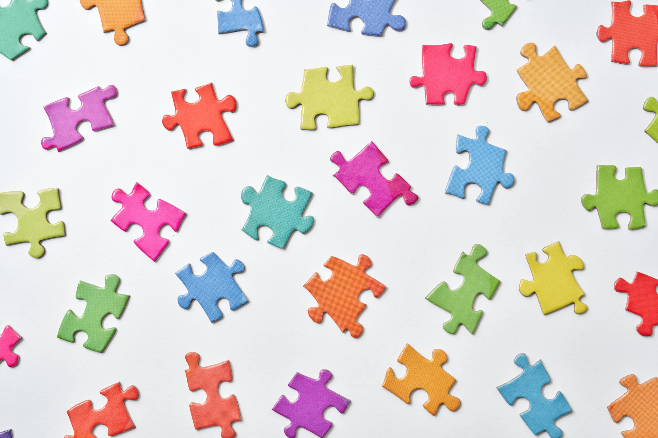 Colorful puzzle pieces representing the complex pieces of an ai vs human writing strategy.