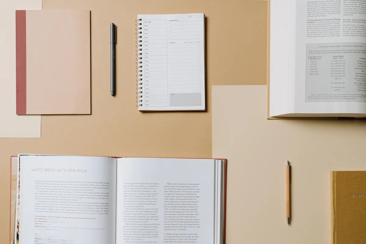Notebooks and open books on a desk, useful for planning an effective answer engine optimization tips.