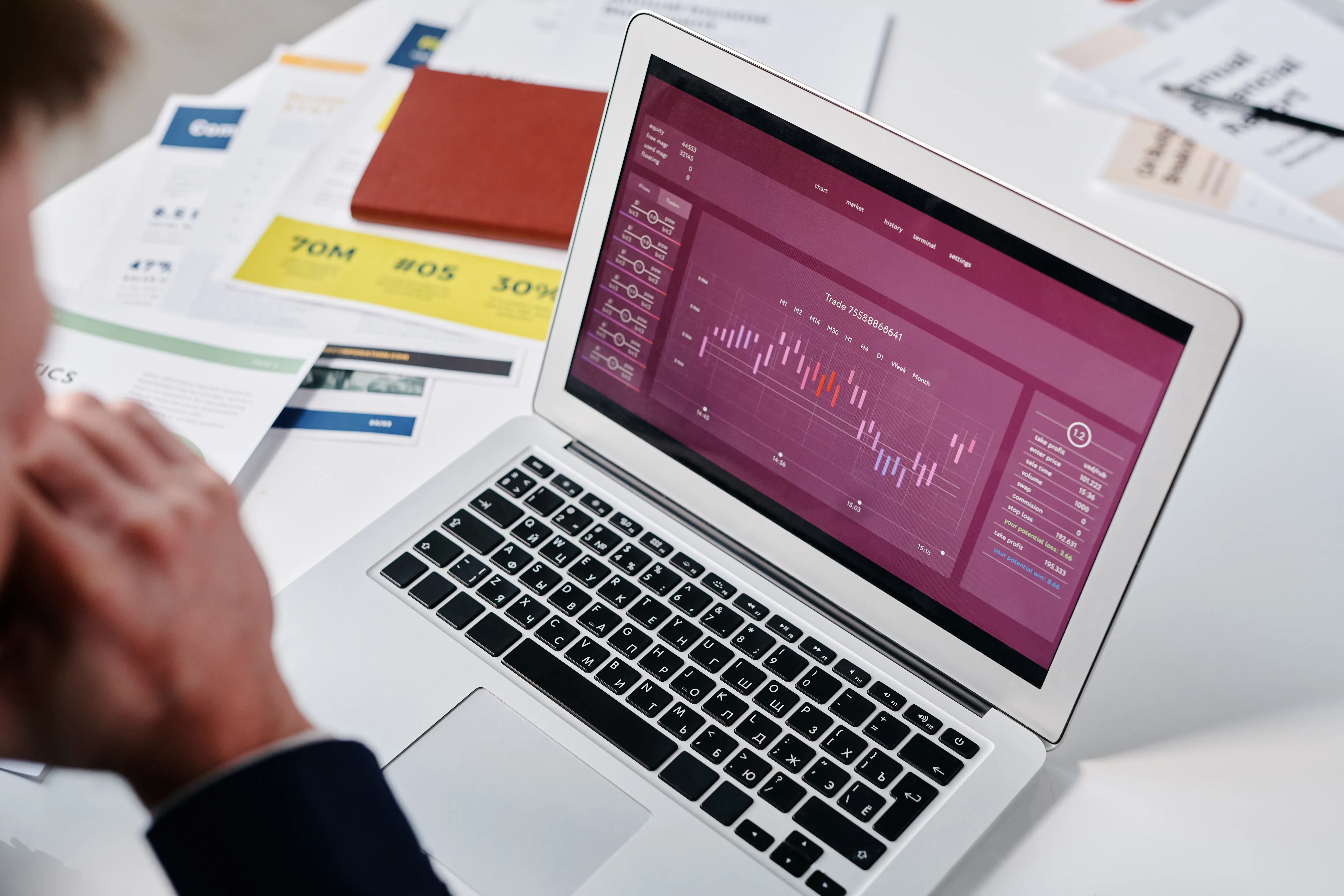A person analyzing financial charts on a laptop screen while working on generative engine optimization strategies.