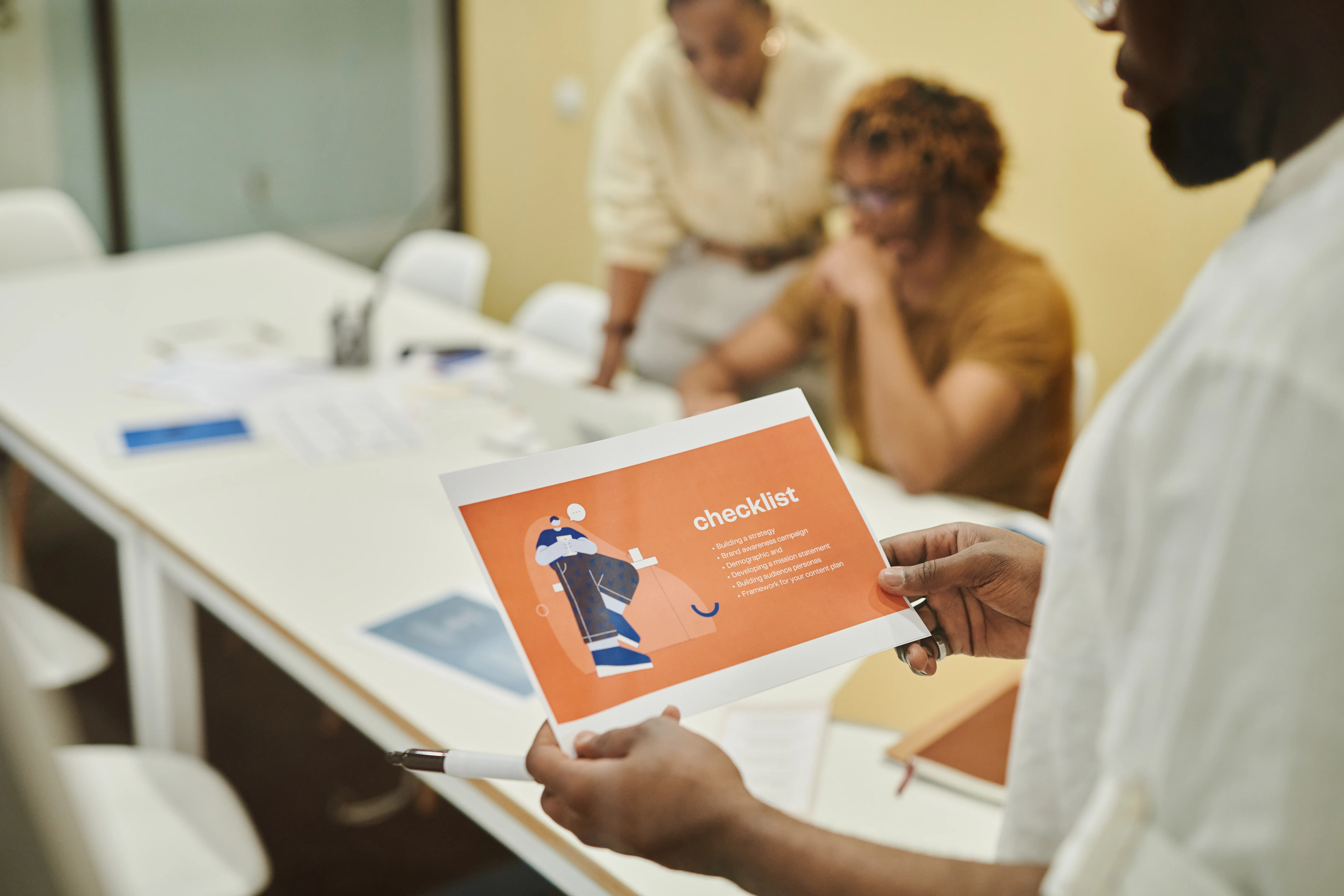Team members reviewing a checklist to optimize content for ai engines during a strategy meeting.