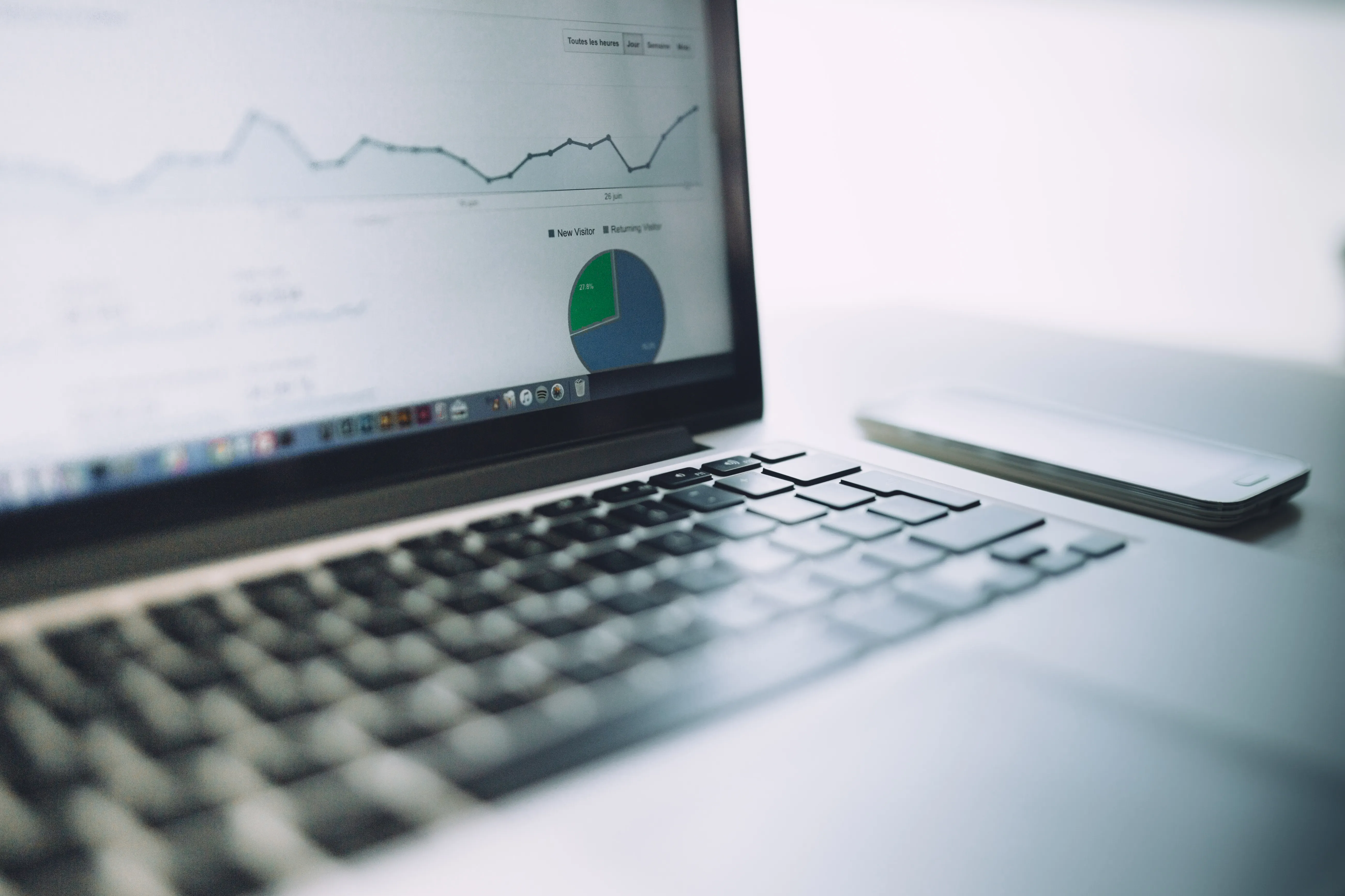 A laptop showing analytics data and charts to measure artificial intelligence SEO performance metrics.