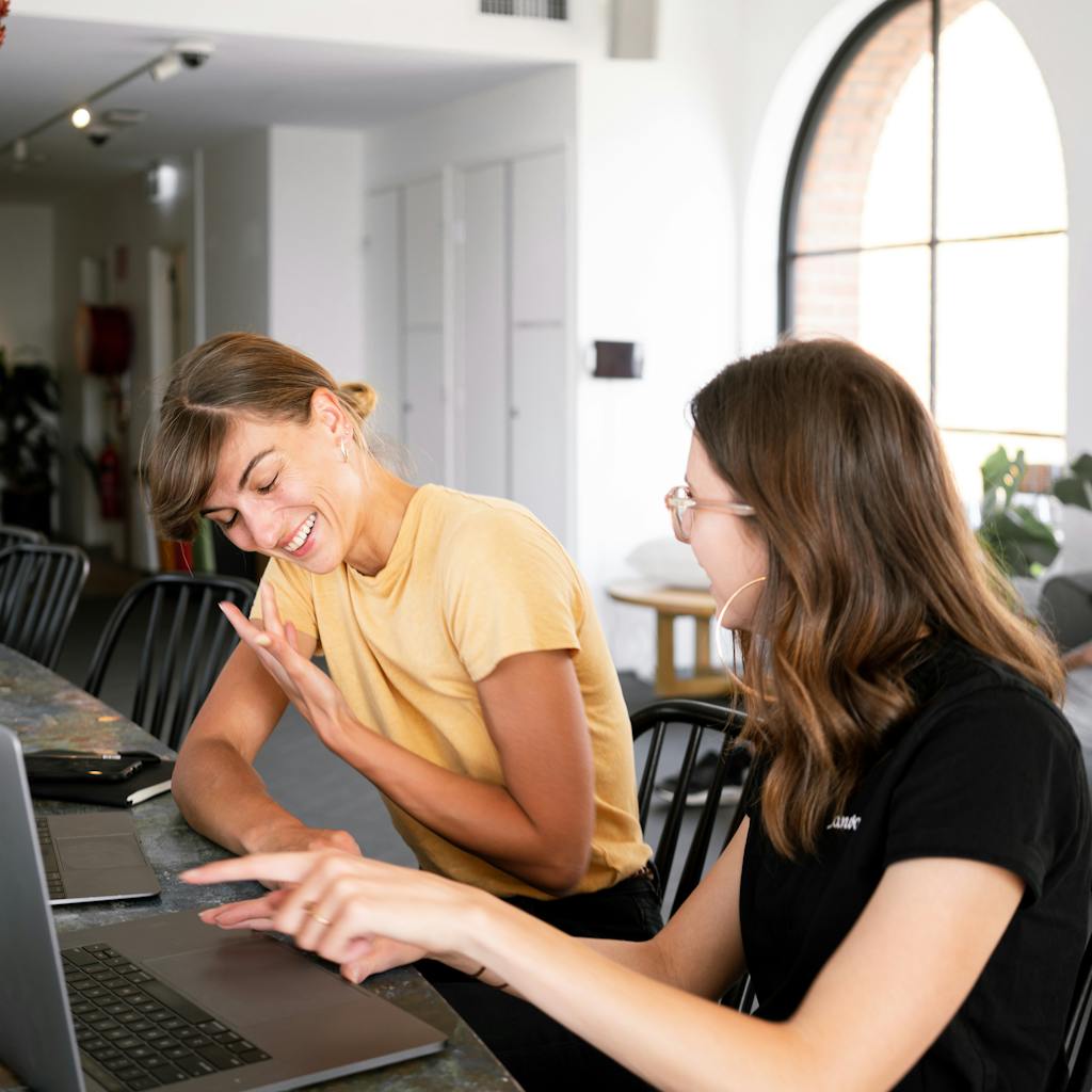 A person thoughtfully crafting a prompt on a laptop, with a glowing ChatGPT interface in the background. Focus on the thoughtful expression and the blend of human creativity with AI technology.