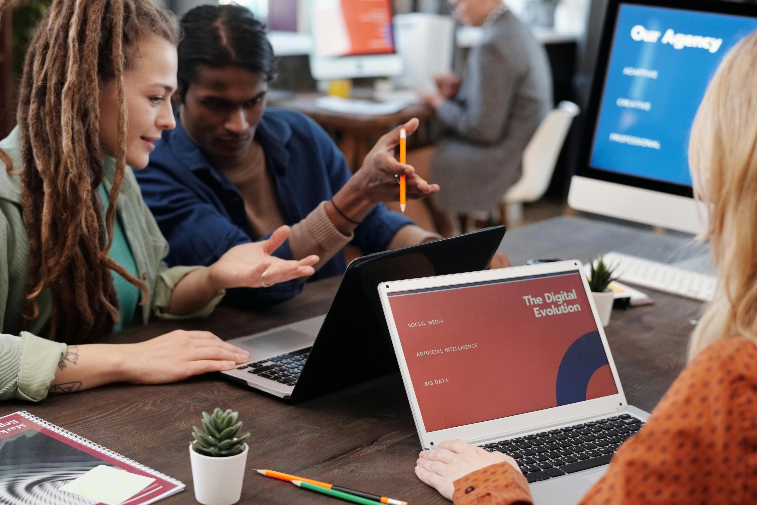A diverse group of people collaborating around a table, brainstorming ideas on a whiteboard, with AI-generated suggestions appearing on a nearby screen.